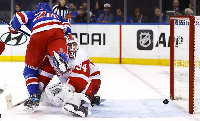 New York Rangers left wing Chris Kreider scores a goal against Detroit Red Wings goaltender Alex Lyon (34) during the second period of a hockey game, Monday, Oct. 14, 2024, in New York. (AP Photo/Noah K. Murray)