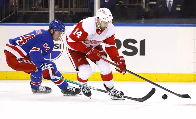 Detroit Red Wings center Tyler Motte (14) plays the puck against New York Rangers center Adam Edstrom (84) during the second period of a hockey game, Monday, Oct. 14, 2024, in New York. (AP Photo/Noah K. Murray)