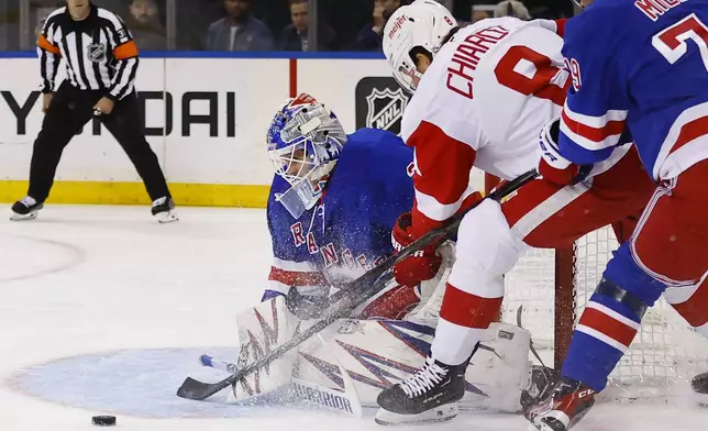 New York Rangers goaltender Igor Shesterkin makes a save against Detroit Red Wings defenseman Ben Chiarot during the first period of a hockey game, Monday, Oct. 14, 2024, in New York. (AP Photo/Noah K. Murray)