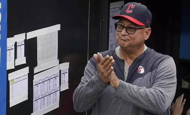 FILE -Cleveland Guardians manager Terry Francona applauds during a tribute video before the team's baseball game against the Cincinnati Reds, Wednesday, Sept. 27, 2023, in Cleveland. Terry Francona has been hired to manage the Cincinnati Reds, returning to the major leagues a year after he stepped down in Cleveland because of health. A person familiar with the situation confirmed the move on Thursday, Oct. 3, 2024 on condition of anonymity because the Reds had not announced the decision.(AP Photo/Sue Ogrocki, File)