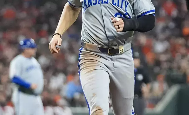 Kansas City Royals' Kyle Isbel scores on an infield single by Bobby Witt Jr. during the sixth inning in Game 2 of an AL Wild Card Series baseball game against the Baltimore Orioles, Wednesday, Oct. 2, 2024 in Baltimore. (AP Photo/Stephanie Scarbrough)