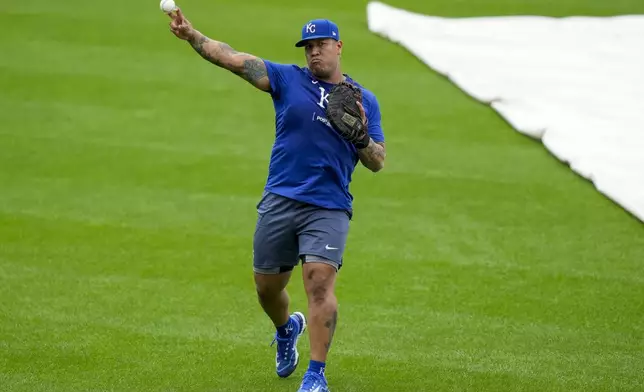 Kansas City Royals catcher Salvador Perez warms up during a baseball workout a day before the team's wild card playoff game against the Baltimore Orioles, Monday, Sept. 30, 2024, in Baltimore. (AP Photo/Stephanie Scarbrough)