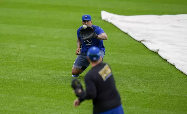 Kansas City Royals catcher Salvador Perez warms up during a baseball workout a day before the team's wild card playoff game against the Baltimore Orioles, Monday, Sept. 30, 2024, in Baltimore. (AP Photo/Stephanie Scarbrough)