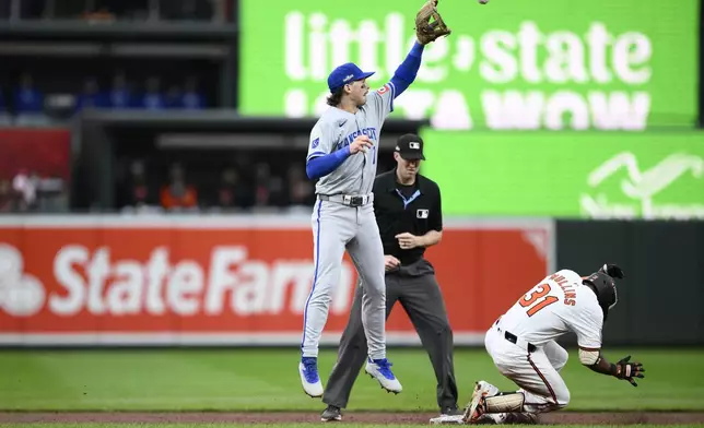 Baltimore Orioles' Cedric Mullins (31) reaches second base with a double against Kansas City Royals shortstop Bobby Witt Jr., left, in the third inning during Game 1 of an AL Wild Card Series baseball game, Tuesday, Oct. 1, 2024, in Baltimore. (AP Photo/Nick Wass)