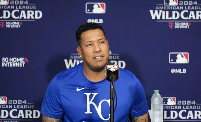 Kansas City Royals catcher Salvador Perez speaks to press before a baseball workout a day before the team's wild card playoff game against the Baltimore Orioles, Monday, Sept. 30, 2024, in Baltimore. (AP Photo/Stephanie Scarbrough)