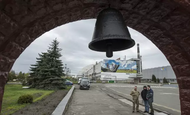 FILE - This April 26, 2023, file photo, shows Ukraine's Chornobyl nuclear power plant seen from a memorial to victims of a 1986 meltdown. To this day, the area around the plant, known in Russian as Chernobyl, is off-limits except to the technical staff needed to keep it safe. (AP Photo/Wladyslaw Musiienko)