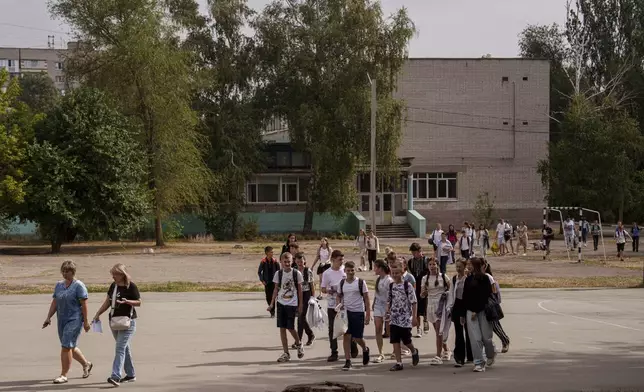 Children from Gymnasium No. 6 go to the school basement to continue their studies during an air alert in Zaporizhzhia, Ukraine, Sept. 3, 2024. (AP Photo/Evgeniy Maloletka)