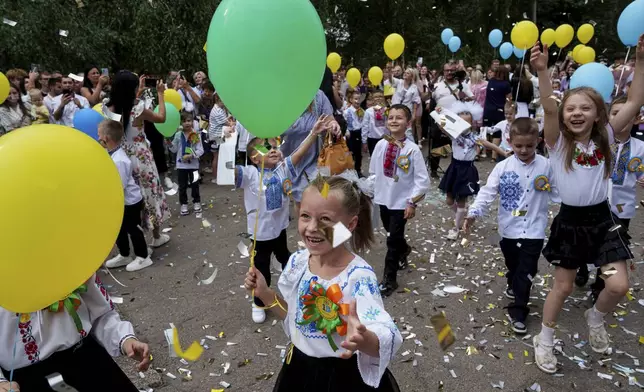 First-graders at Gymnasium No. 6 attend a traditional back-to-school ceremony in Zaporizhzhia, Ukraine, Sept. 1, 2024. (AP Photo/Evgeniy Maloletka)