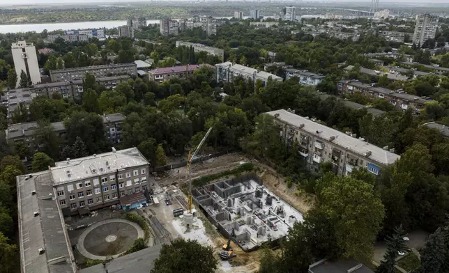 Construction workers dig out an underground school at Gymnasium No. 71 in Zaporizhzhia, Ukraine, Aug. 30, 2024, one of a dozen planned for the city and designed to be radiation- and bomb-proof. (AP Photo/Evgeniy Maloletka)