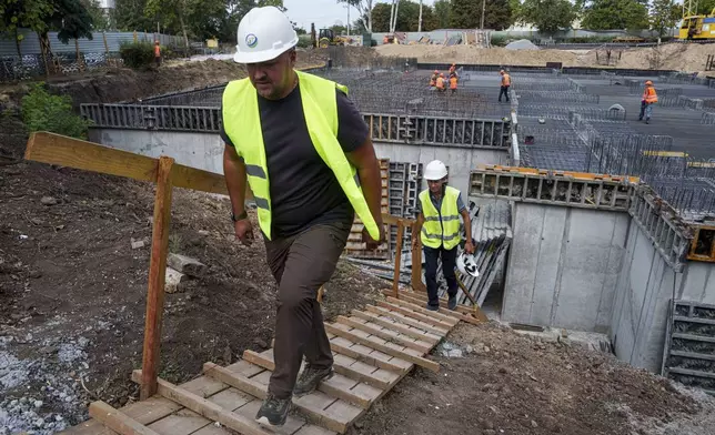 Builders work at the construction site of an underground version of School No. 88 in Zaporizhzhia, Ukraine, August 30, 2024. (AP Photo/Evgeniy Maloletka)