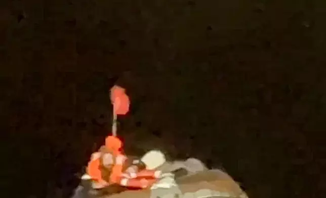 In this photo taken from video released by the official telegram channel of the Russian Far Eastern Transport Prosecutor's Office on Tuesday, Oct. 15, 2024, a Russian man who spent more than two months adrift in an inflatable boat is seen before being rescued by a fishing vessel in the Okhotsk Sea near the village of Ust-Khairuzovo in Kamchatka region of Russian far east. (Official telegram channel of the Russian Far Eastern Transport Prosecutor's Office via AP)