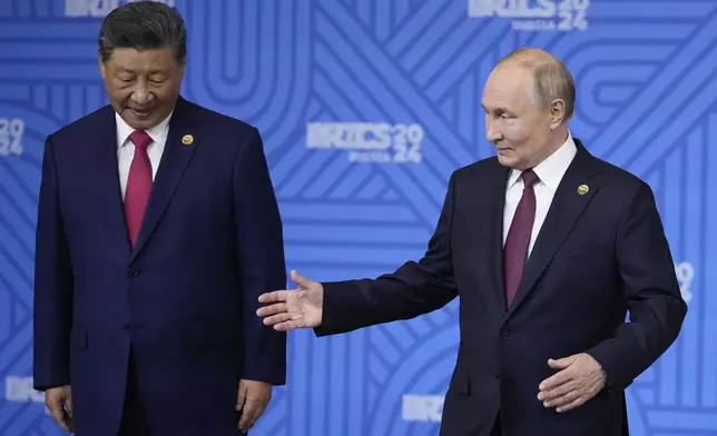 Chinese President Xi Jinping, left, and Russian President Vladimir Putin attend a family photo ceremony prior to the BRICS Summit plenary session in Kazan, Russia, Wednesday, Oct. 23, 2024. (AP Photo/Alexander Zemlianichenko, Pool)