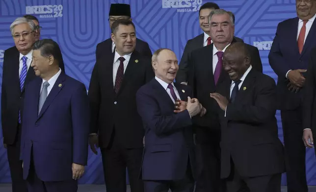 Russian President Vladimir Putin, center, and South African President Cyril Ramaphosa laugh during a family photo ceremony prior to Outreach/BRICS Plus format session at BRICS Summit in Kazan, Russia, Thursday, Oct. 24, 2024. (Maxim Shipenkov, Pool Photo via AP)