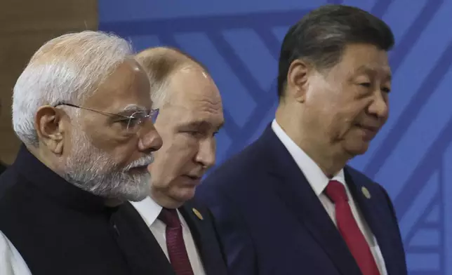 From left: Indian Prime Minister Narendra Modi, Russian President Vladimir Putin and Chinese President Xi Jinping attend a family photo prior to the BRICS Summit plenary session in Kazan, Russia, Wednesday, Oct. 23, 2024. (Maxim Shipenkov, Pool Photo via AP)