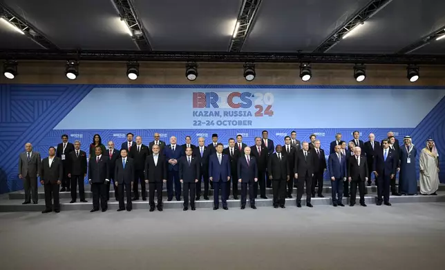 The heads of delegations pose for a family photo prior to Outreach/BRICS Plus format session at the BRICS Summit in Kazan, Russia, Thursday, Oct. 24, 2024. (Alexander Nemenov, Pool Photo via AP)