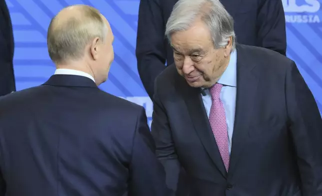 Russian President Vladimir Putin, left, and United Nations Secretary-General Antonio Guterres shake hands during family photo ceremony prior to Outreach/BRICS Plus format session on the sidelines of the BRICS summit in Kazan, Russia, Thursday, Oct. 24, 2024. (Grigory Sysoyev/Photo host brics-russia2024.ru via AP)