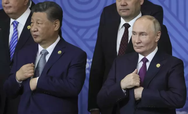 Chinese President Xi Jinping, left, and Russian President Vladimir Putin attend a family photo ceremony prior to Outreach/BRICS Plus format session at the BRICS Summit in Kazan, Russia, Thursday, Oct. 24, 2024. (Maxim Shipenkov, Pool Photo via AP)