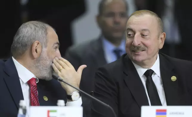Armenian Prime Minister Nikol Pashinyan, left, and Azerbaijani President Ilham Aliyev attend Outreach/BRICS Plus format session on the sidelines of the BRICS summit in Kazan, Russia, Thursday, Oct. 24, 2024. (Ramil Sitdikov/Photo host brics-russia2024.ru via AP)