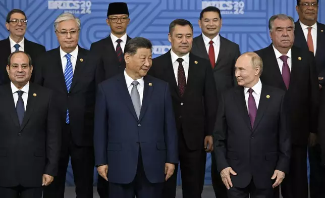 Russian President Vladimir Putin, right, and other participants pose for a family photo prior to Outreach/BRICS Plus format session at BRICS Summit in Kazan, Russia, Thursday, Oct. 24, 2024. (Alexander Nemenov, Pool Photo via AP)