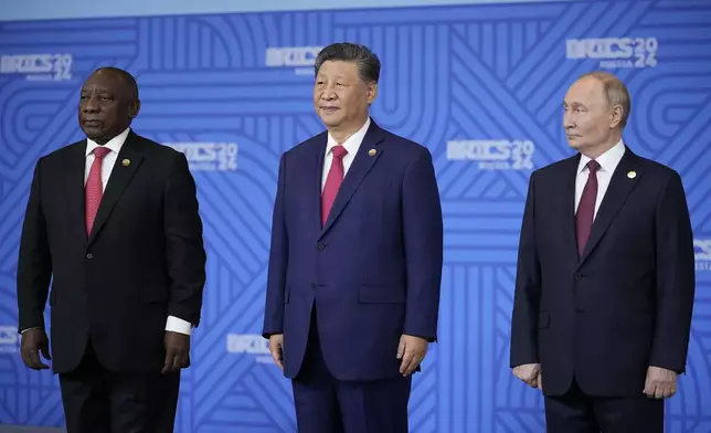 From left: South African President Cyril Ramaphosa, Chinese President Xi Jinping and Russian President Vladimir Putin pose for a family photo prior to the BRICS Summit plenary session in Kazan, Russia, Wednesday, Oct. 23, 2024. (AP Photo/Alexander Zemlianichenko, Pool)