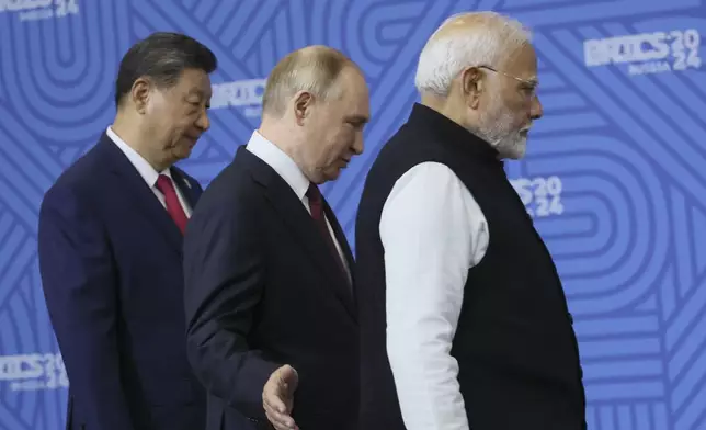 From left: Chinese President Xi Jinping, Russian President Vladimir Putin and Indian Prime Minister Narendra Modi attend a family photo ceremony prior to the BRICS Summit plenary session in Kazan, Russia, Wednesday, Oct. 23, 2024. (Maxim Shipenkov, Pool Photo via AP)