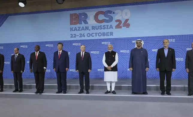 From left: Ethiopian Prime Minister Abiy Ahmed, Egyptian President Abdel Fattah el-Sisi, South African President Cyril Ramaphosa, Chinese President Xi Jinping, Russian President Vladimir Putin, Indian Prime Minister Narendra Modi, United Arab Emirates President Sheikh Mohammed bin Zayed Al Nahyan, Iranian President Masoud Pezeshkian and Brazilian Foreign Minister Mauro Vieira pose for a family photo prior to the BRICS Summit plenary session in Kazan, Russia, Wednesday, Oct. 23, 2024. (Maxim Shipenkov, Pool Photo via AP)