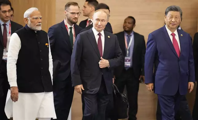 From left, Indian Prime Minister Narendra Modi, Russian President Vladimir Putin and Chinese President Xi Jinping attend a family photo ceremony prior to the BRICS Summit plenary session in Kazan, Russia, Wednesday, Oct. 23, 2024. (AP Photo/Alexander Zemlianichenko, Pool)