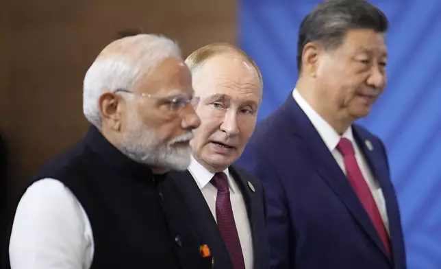 From left, Indian Prime Minister Narendra Modi, Russian President Vladimir Putin and Chinese President Xi Jinping attend a family photo ceremony prior to the BRICS Summit plenary session in Kazan, Russia, Wednesday, Oct. 23, 2024. (AP Photo/Alexander Zemlianichenko, Pool)