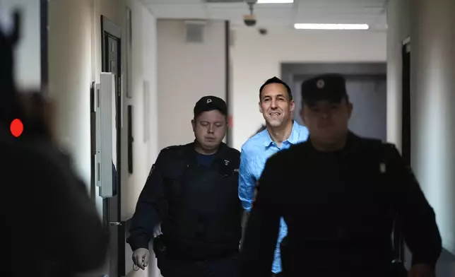 French citizen Laurent Vinatier is escorted to a court room at the Zamoskvoretsky District Court in Moscow, Russia, on Monday, Oct. 14, 2024. (AP Photo/Pavel Bednyakov)