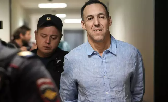 French citizen Laurent Vinatier is escorted to a court room at the Zamoskvoretsky District Court in Moscow, Russia, on Monday, Oct. 14, 2024. (AP Photo/Pavel Bednyakov)