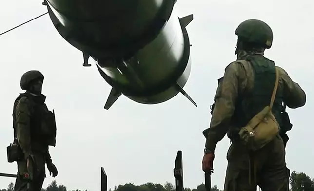 FILE - In this image taken form video released by the Russian Defense Ministry Press Service on June 12, 2024, Russian soldiers load an Iskander-M short-range ballistic missile launchers at a firing position as part of Russian military drill intended to train the troops in using tactical nuclear weapons. (Russian Defense Ministry Press Service via AP, File)