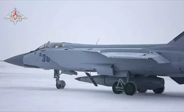 FILE - This image taken from video released by the Russian Defense Ministry Press Service on Feb. 19, 2022, shows a MiG-31K fighter of the Russian air force carrying a Kinzhal hypersonic cruise missile parked at an air field during a military drills. (Russian Defense Ministry Press Service via AP, File)