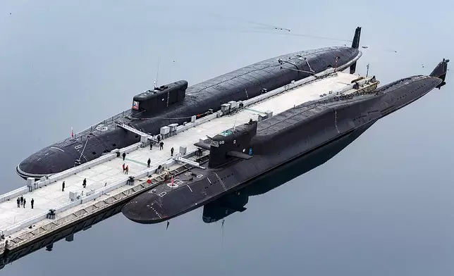 FILE - In this photo released by Russian Defense Ministry Press Service on April 13, 2021, Russian nuclear submarines Prince Vladimir, above, and Yekaterinburg are harbored at a Russian naval base in Gazhiyevo, Kola Peninsula, Russia. (Russian Defense Ministry Press Service via AP, File)