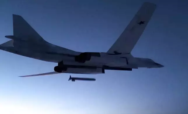 FILE - In this image taken from a video distributed by Russian Defense Ministry Press Service, on Dec. 9, 2020, a Russian Tu-160 strategic bomber fires a cruise missile at test targets, during a military drills in Russia. (Russian Defense Ministry Press Service via AP, File)