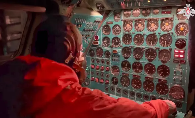 In this photo taken from video distributed by Russian Defense Ministry Press Service on Tuesday, Oct. 29, 2024, a Russian air force crew member oversees an instrument panel on board a Tu-95 nuclear-capable strategic bomber during drills of Russia's nuclear forces. (Russian Defense Ministry Press Service via AP)