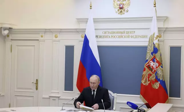 Russian President Vladimir Putin takes part in an exercise of Russia's strategic nuclear deterrence forces to train actions of officials on operating nuclear weapons with practical launches of ballistic and cruise missiles, at the Kremlin in Moscow, Russia, Tuesday, Oct. 29, 2024. (Mikhail Metzel, Sputnik, Kremlin Pool Photo via AP)