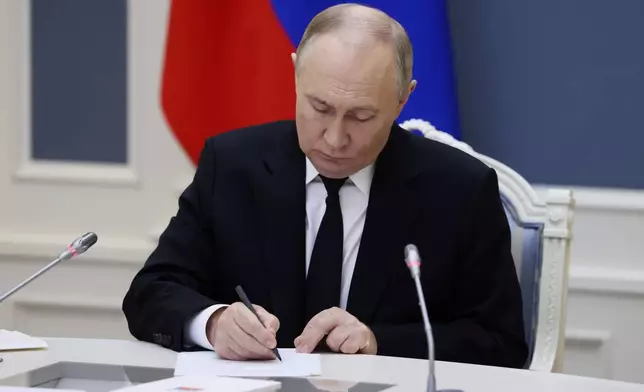 Russian President Vladimir Putin takes part in an exercise of Russia's strategic nuclear deterrence forces to train actions of officials on operating nuclear weapons with practical launches of ballistic and cruise missiles, at the Kremlin in Moscow, Russia, Tuesday, Oct. 29, 2024. (Mikhail Metzel, Sputnik, Kremlin Pool Photo via AP)