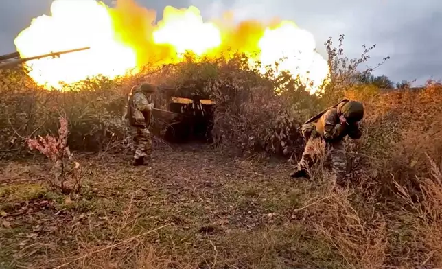 In this photo taken from video distributed by Russian Defense Ministry Press Service on Wednesday, Oct. 30, 2024, Russian soldiers fire a 152 mm gun Giatsint-B from their position at an undisclosed location in Ukraine. (Russian Defense Ministry Press Service via AP)