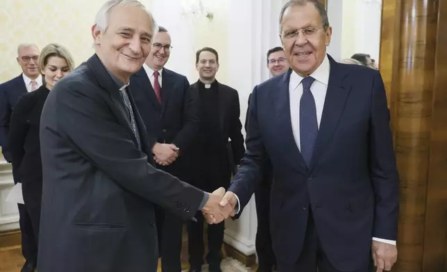 In this photo released by Russian Foreign Ministry press service on Monday, Oct. 14, 2024, Russian Foreign Minister Sergey Lavrov, right, and the President of the Italian Conference of Bishops, Pope Francis' special envoy to pursue peace in Ukraine Cardinal Matteo Zuppi, left, shake hands during their meeting in Moscow, Russia. (Russian Foreign Ministry Press Service via AP)