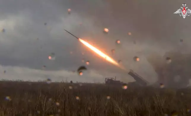 In this photo taken from video distributed by the Russian Defense Ministry Press Service on Wednesday, Oct. 30, 2024, a Russian self-propelled multiple rocket launcher Uragan (Hurricane) fires toward Ukrainian position at an undisclosed location in Ukraine. (Russian Defense Ministry Press Service via AP)