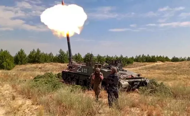 In this photo taken from video distributed by Russian Defense Ministry Press Service on Wednesday, Oct. 30, 2024, Russian soldiers fire a Tyulpan self-propelled heavy mortar from their position at an undisclosed location in Ukraine. (Russian Defense Ministry Press Service via AP)