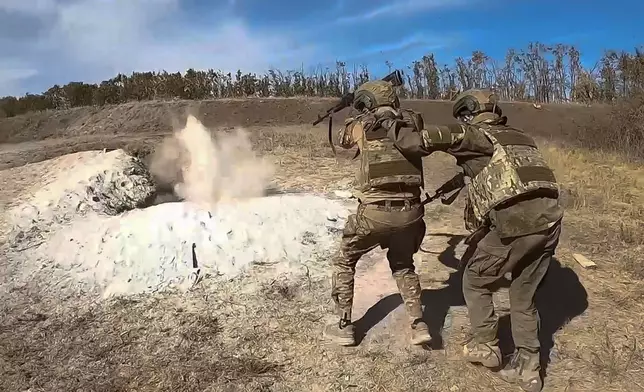 In this photo released by Russian Defense Ministry Press Service on Wednesday, Oct. 2, 2024, Russian soldiers attend combat training for assault units at an undisclosed location in Ukraine. (Russian Defense Ministry Press Service via AP)