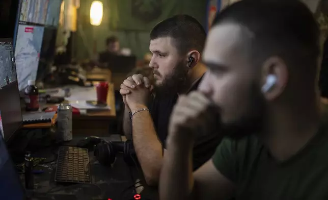 Ukrainian servicemen of Khartia brigade control the drone aerial view in the command centre in Kharkiv region, Ukraine, Wednesday, Oct. 16, 2024. (AP Photo/Alex Babenko)