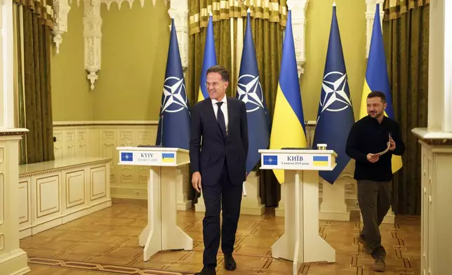 NATO Secretary General Mark Rutte, left, and Ukrainian President Volodymyr Zelenskyy leave the hall after a joint press conference in Kyiv, Ukraine, Thursday Oct. 3, 2024. (AP Photo/Evgeniy Maloletka)