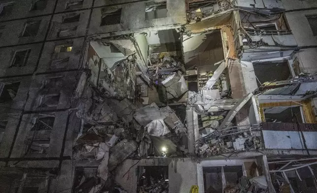 A multi-storey apartment building is seen damaged by the Russian attack in Kharkiv, Ukraine, late Wednesday, Oct. 30, 2024. (AP Photo/Andrii Marienko)