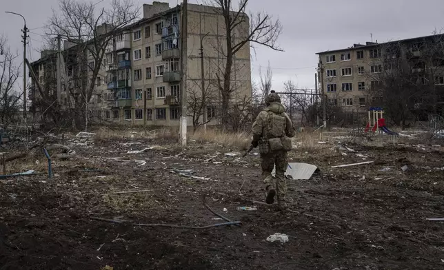 FILE - A Ukrainian marine serviceman runs to take a position through the residential blocks in the frontline city of Vuhledar, Ukraine, Feb. 25, 2023. (AP Photo/Evgeniy Maloletka, File)