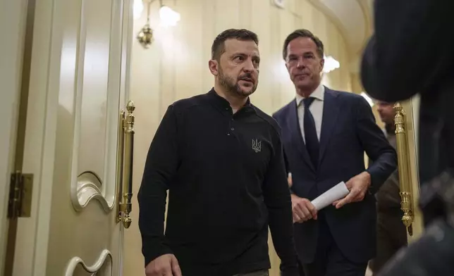 NATO Secretary General Mark Rutte, right, and Ukrainian President Volodymyr Zelenskyy walk in a corridor before a press conference in Kyiv, Ukraine, Thursday Oct. 3, 2024. (AP Photo/Evgeniy Maloletka)