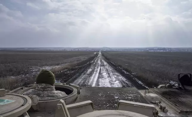 FILE - A Ukrainian serviceman of 68 Oleksa Dovbush hunting brigade drives by M113 armoured vehicle towards frontline positions near Vuhledar, Ukraine, Feb. 22, 2023. (AP Photo/Evgeniy Maloletka, File)