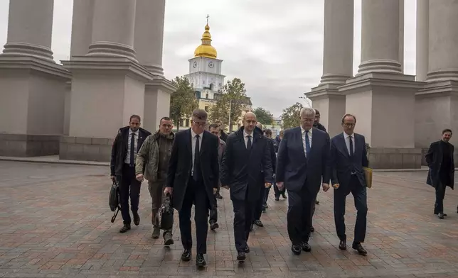 French Foreign Minister Jean-Noel Barrot and Ukrainian Minister of Foreign Affairs Andrii Sybiha walk towards Ministry of Foreign Affairs in central Kyiv, Ukraine, Saturday, Oct. 19, 2024. (AP Photo/Alex Babenko)