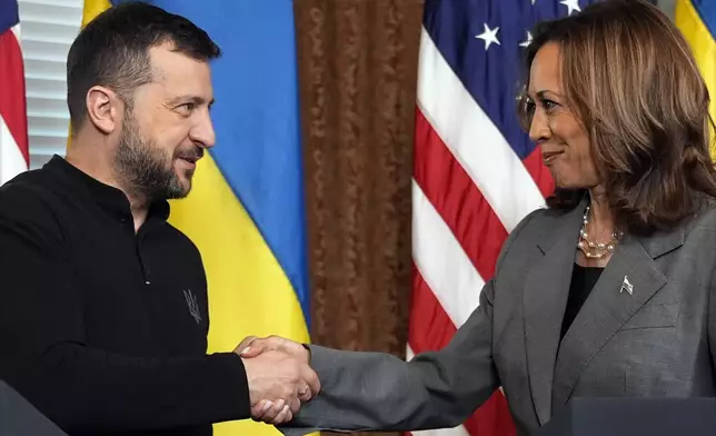 FILE - Vice President Kamala Harris, right, and Ukraine's President Volodymyr Zelenskyy, shake hands during their meeting on Sept. 26, 2024, in the vice president's ceremonial office inside the Eisenhower Executive Office Building on the White House complex in Washington. (AP Photo/Jacquelyn Martin, File)